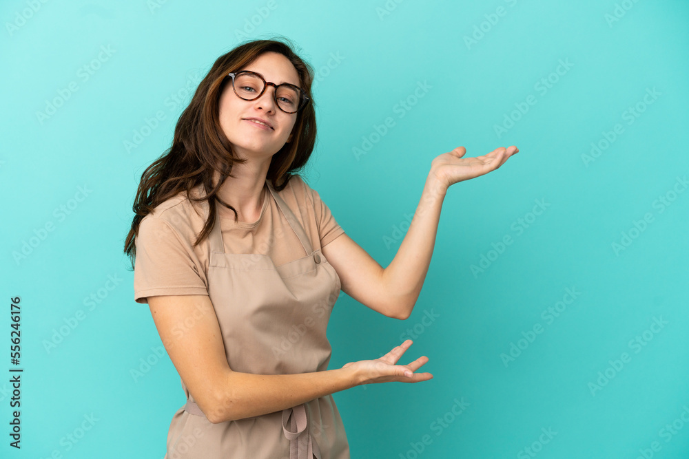 Restaurant waiter extending hands to the side for inviting to come Restaurant waiter extending hands to the side for inviting to come
