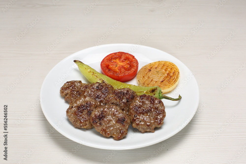 grilled meatball with grilled pepper, tomato and onion slice