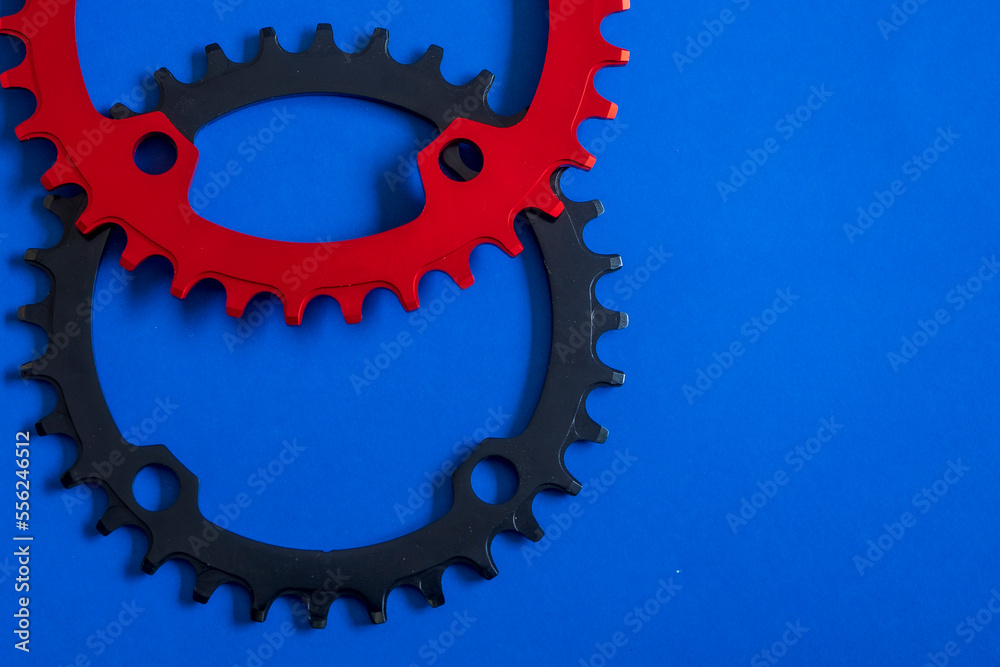 Bicycles chainrings on blue background with copy space Bicycles chainrings on blue background with copy space