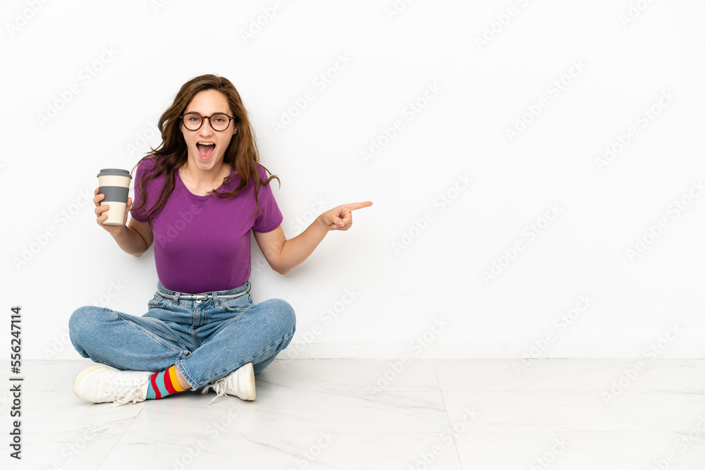 Young caucasian woman isolated on white background surprised and pointing finger to the side Young caucasian woman isolated on white background surprised and pointing finger to the side