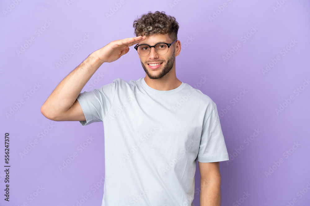 Delivery caucasian man isolated on purple background saluting with hand with happy expression Delivery caucasian man isolated on purple background saluting with hand with happy expression