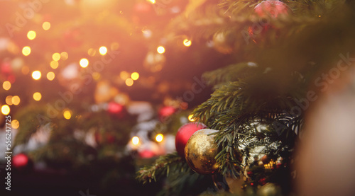 Banner photo gold and red ball decorated christmas tree pine on blurred background bokeh sun light