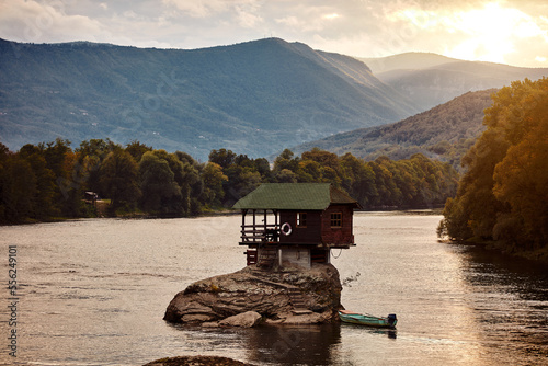 Small wooden cabin on a rock in the middle of river Drina, Serbia.. photo