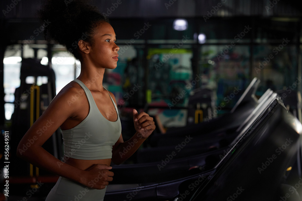 young sports woman working out and running on treadmill in gym young sports woman working out and running on treadmill in gym