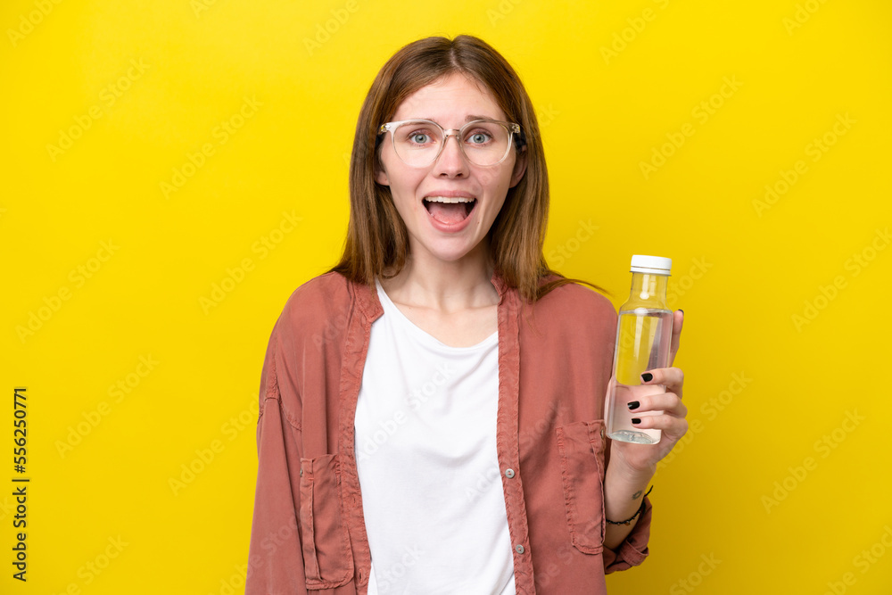 Young English woman with a bottle of water isolated on yellow background with surprise facial expression Young English woman with a bottle of water isolated on yellow background with surprise facial expression