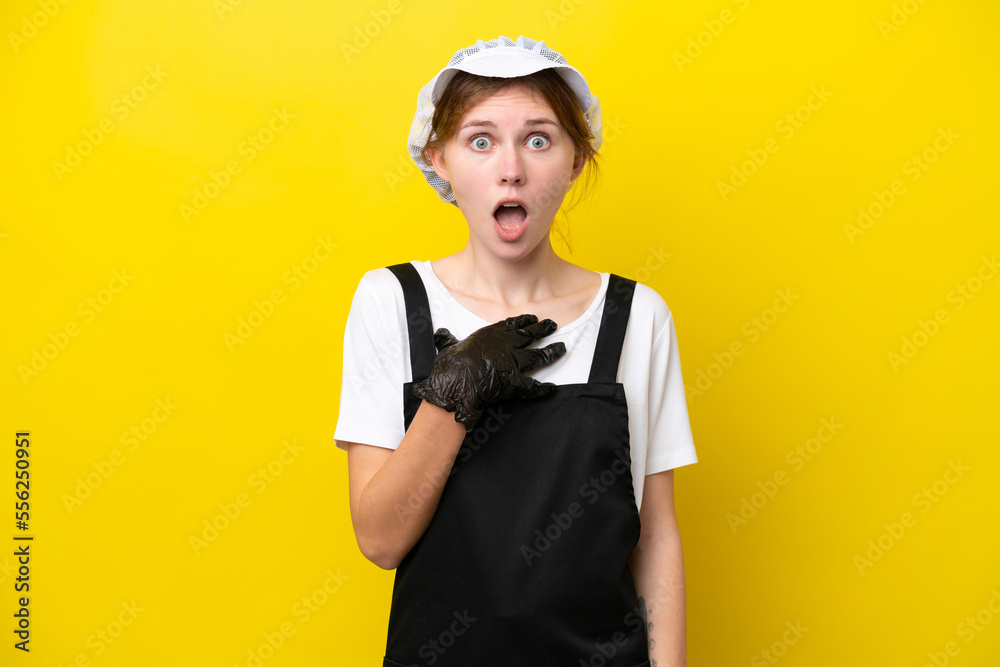 Young English fisherwoman isolated on yellow background surprised and shocked while looking right Young English fisherwoman isolated on yellow background surprised and shocked while looking right