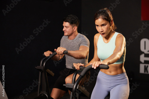 young sporty woman cycling exercise bikes at the gym