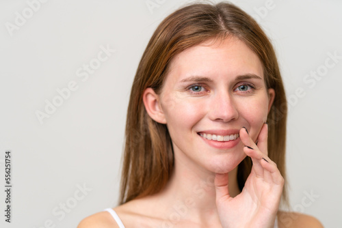 Portrait of pretty young woman over isolated white background