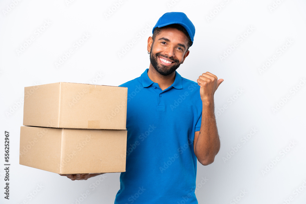 Delivery Brazilian man isolated on white background pointing to the side to present a product Delivery Brazilian man isolated on white background pointing to the side to present a product