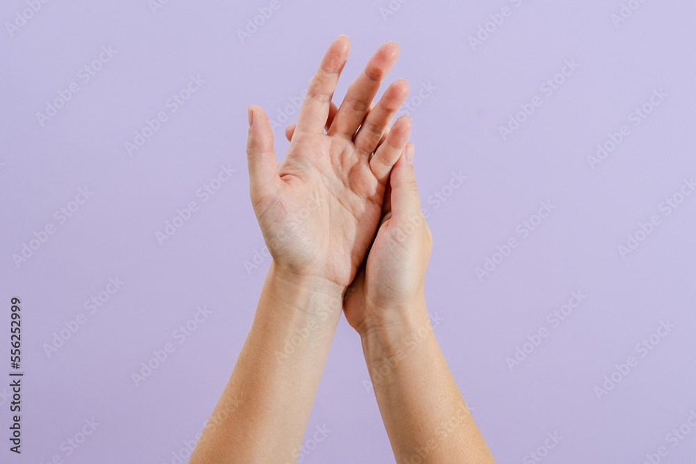 Woman's hands on lilac background. Skin care for hands, manicure and beauty treatment. Woman's hands on lilac background. Skin care for hands, manicure and beauty treatment.