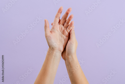 Woman s hands on lilac background. Skin care for hands  manicure and beauty treatment.