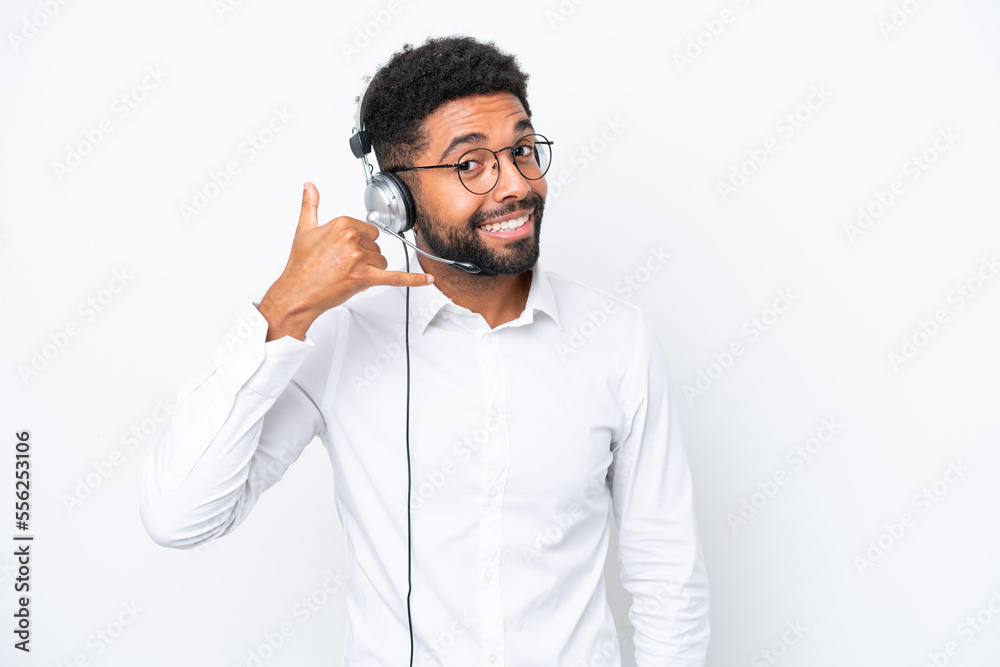 Telemarketer Brazilian man working with a headset isolated on white background making phone gesture. Call me back sign Telemarketer Brazilian man working with a headset isolated on white background making phone gesture. Call me back sign