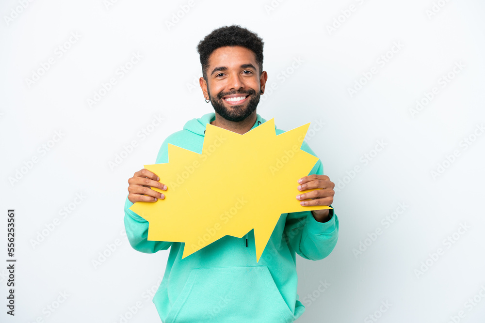 Young Brazilian man isolated on white background holding an empty speech bubble Young Brazilian man isolated on white background holding an empty speech bubble