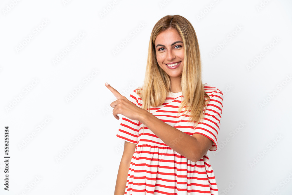 Blonde Uruguayan girl isolated on white background pointing to the side to present a product Blonde Uruguayan girl isolated on white background pointing to the side to present a product