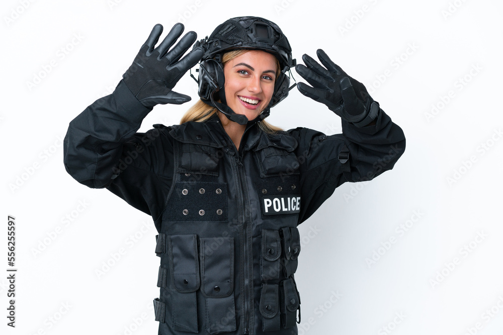 SWAT caucasian woman isolated on white background counting nine with fingers