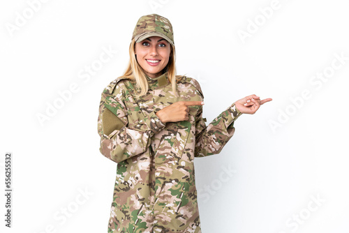 Military woman isolated on white background surprised and pointing side