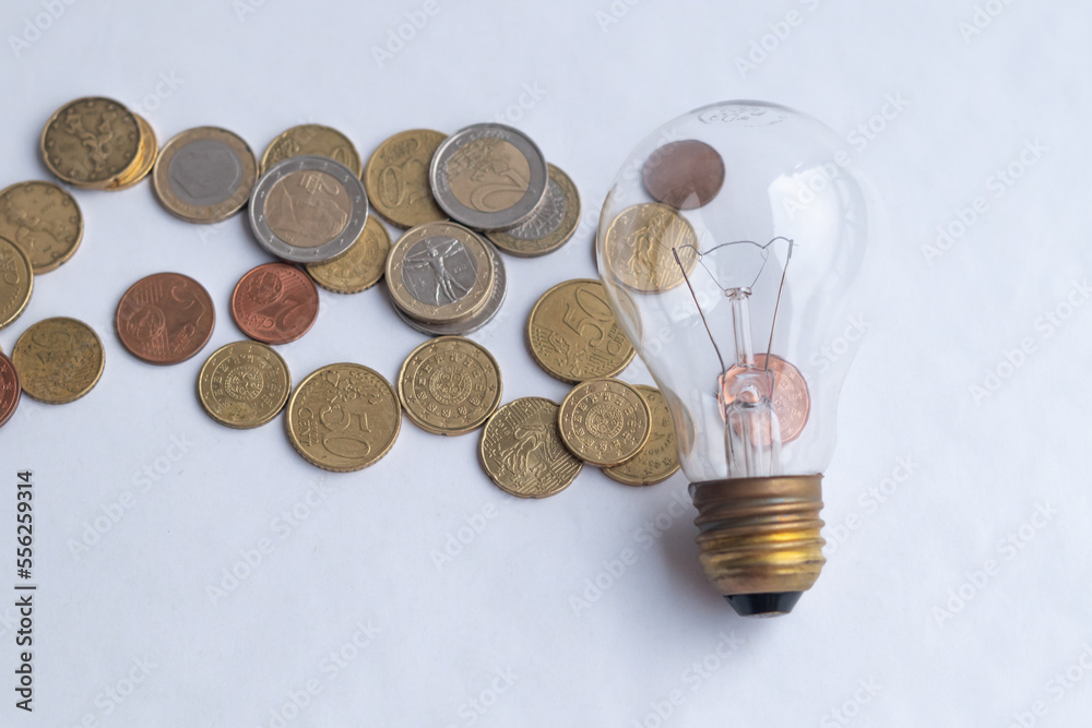 Economical light bulb and money. Energy saving.Transparent light bulbs and energy saving lamp. Economical light bulb and money. Energy saving.Transparent light bulbs and energy saving lamp.