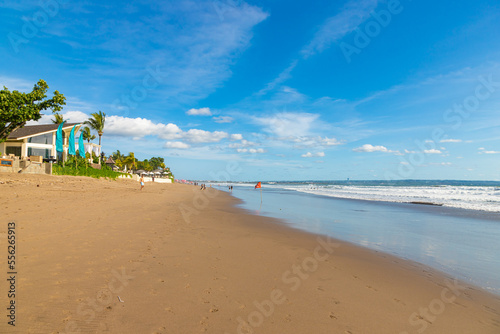 BALI, INDONESIA - OCTOBER 29, 2022: People walking on Petitenget beach with modern and expensive restaurants and hotels photo