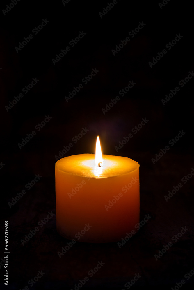 A light of the white candle in a dark room. A light of the white candle in a dark room.