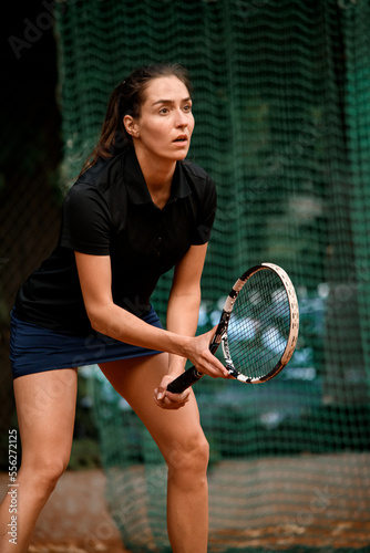 view of athletic female tennis player with tennis racket in her hand. Outdoor tennis practice. © fesenko
