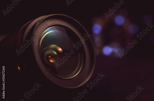 Camera lens close-up, lights out of focus on the background