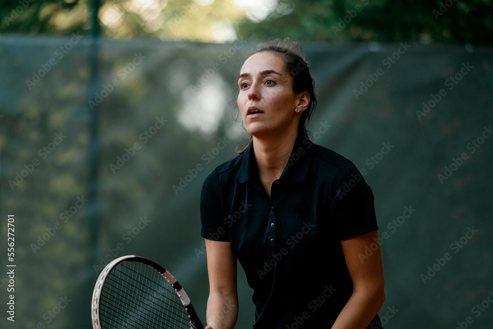 portrait of female tennis player with tennis racket in her hand.