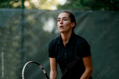 portrait of female tennis player with tennis racket in her hand. © fesenko