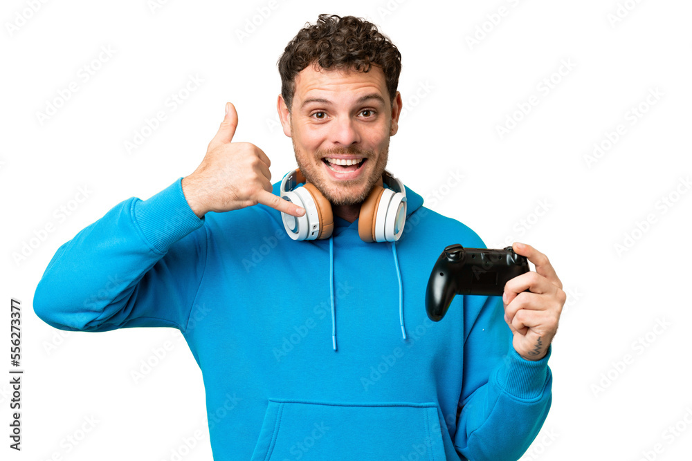 Brazilian man playing with a video game controller over isolated chroma key background making phone gesture. Call me back sign Brazilian man playing with a video game controller over isolated chroma key background making phone gesture. Call me back sign