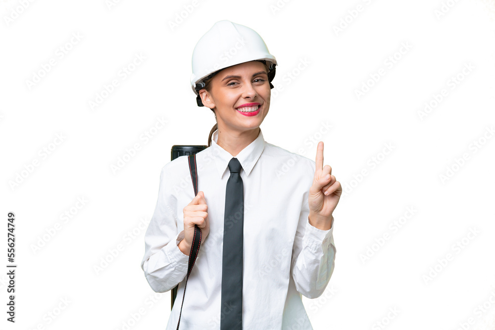 Young architect woman with helmet and holding blueprints over isolated background showing and lifting a finger in sign of the best