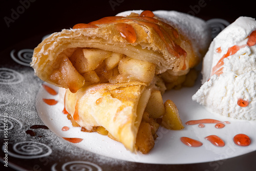 Baked strudel with apple, jam and ice cream photo