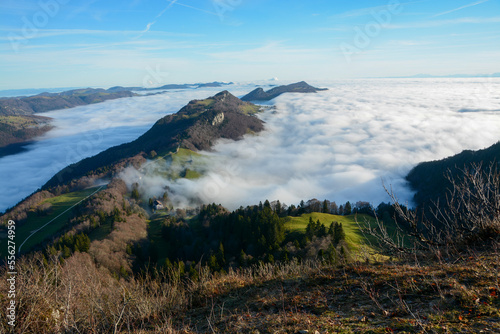 Beautiful Balmberg mountain ridge just above a huge sea of clouds in nice morning sunlight on a wintery day, Solothurn Jura, Switzerland