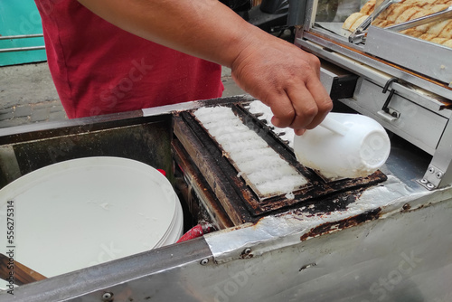 Kue Pancong, Gandos or Bandros is an Indonesian traditional snack made from a mixture of rice flour, grated coconut, and coconut milk.
 photo