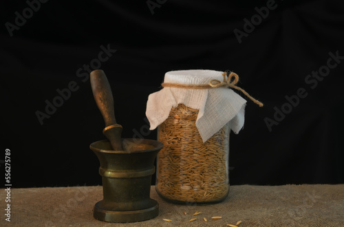 Still life with a mortar,  grains and a can
