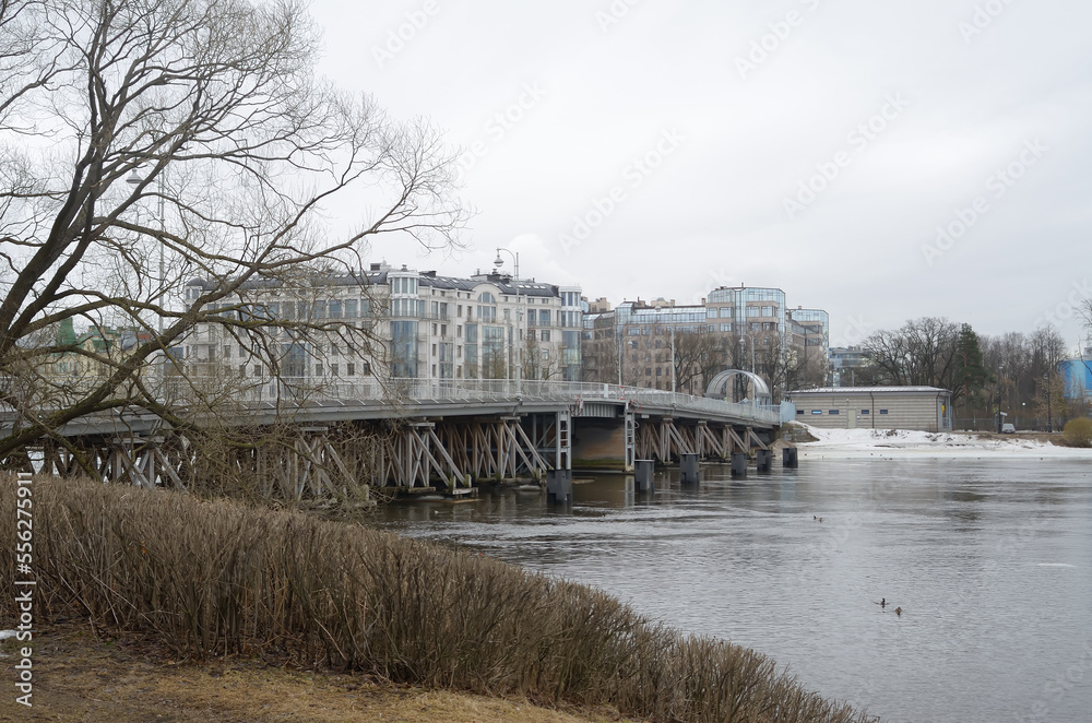 A view of the bridge and city from the river bank in winter