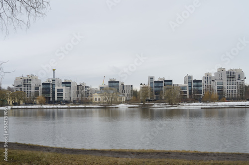 A view from the river bank to multi -storey beautiful buildings in a modern single style