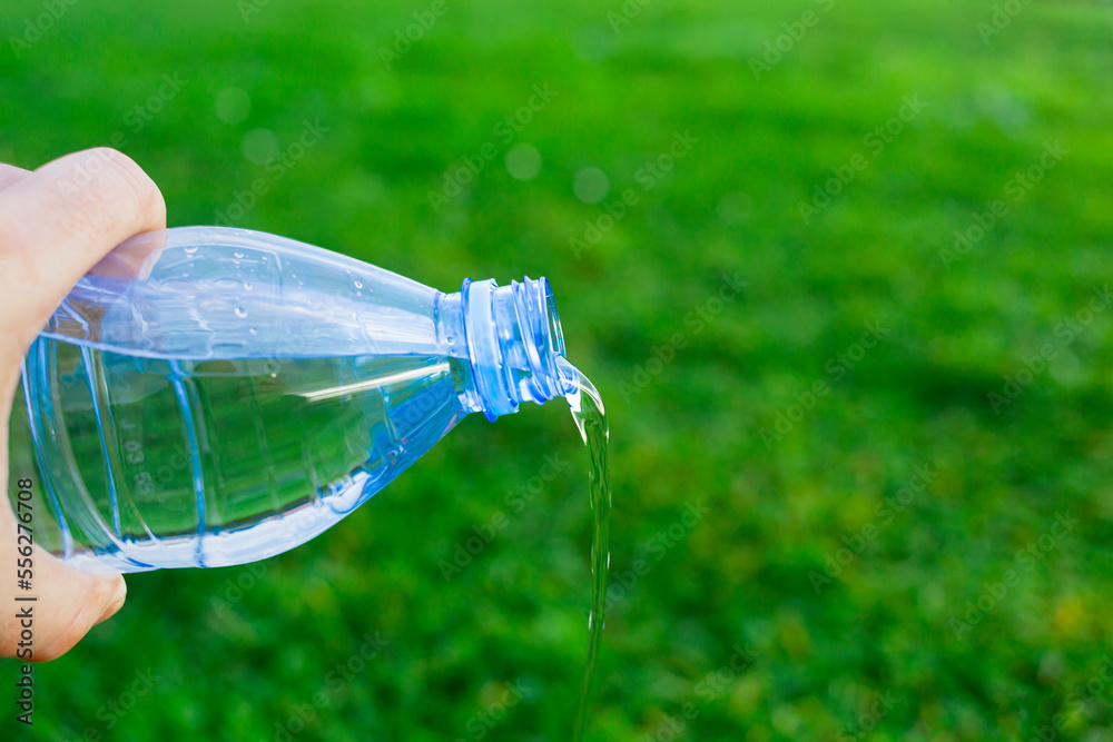 Save the water concept. plastic bottle spilling water on the ground