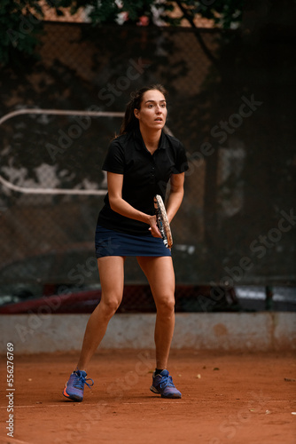 close-up of excited athletic woman tennis player with racket in her hands on tennis court © fesenko