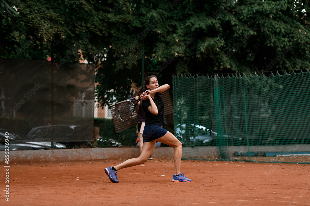 view of sports female tennis player with racket ready to hit tennis ball flying towards her.