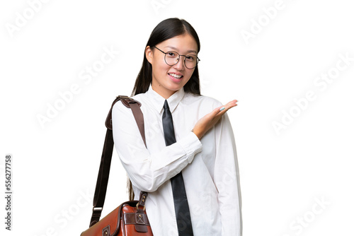 Young Asian business woman over isolated background presenting an idea while looking smiling towards
