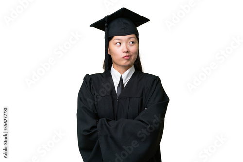 Young university graduate Asian woman over isolated background making doubts gesture while lifting the shoulders