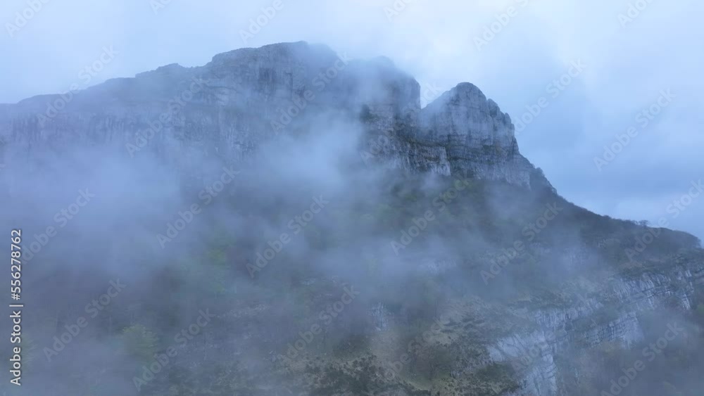Landscape of fogs in the surroundings of the Ason river waterfall. Aerial view from a drone. Hills of the Ason Natural Park. Soba Valley, Cantabria, Spain, Europe Landscape of fogs in the surroundings of the Ason river waterfall. Aerial view from a drone. Hills of the Ason Natural Park. Soba Valley, Cantabria, Spain, Europe