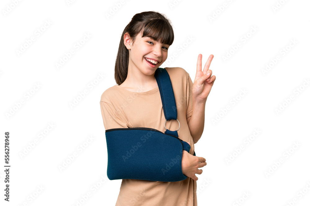 Little caucasian girl with broken arm and wearing a sling over isolated background smiling and showing victory sign Little caucasian girl with broken arm and wearing a sling over isolated background smiling and showing victory sign