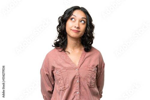 Young Argentinian woman over isolated background and looking up photo