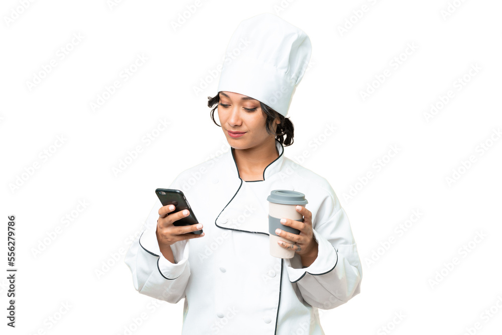 Young chef Argentinian woman over isolated background holding coffee to take away and a mobile Young chef Argentinian woman over isolated background holding coffee to take away and a mobile