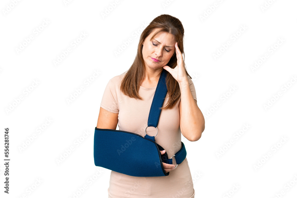 Middle age with broken arm and wearing a sling over isolated background with headache Middle age with broken arm and wearing a sling over isolated background with headache