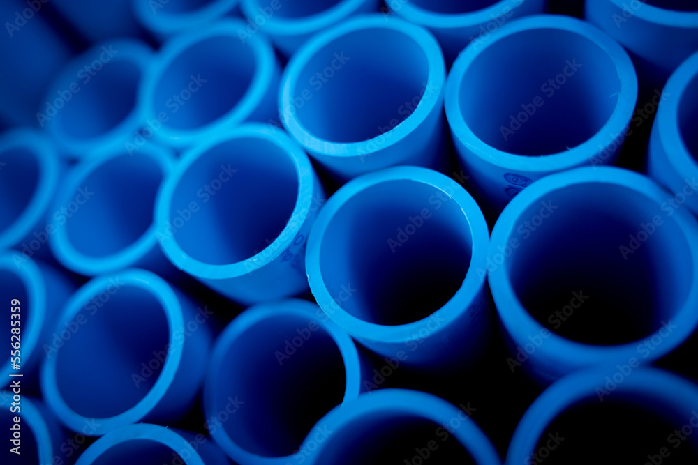 Background of the blue plastic pipes in stacked Background of the blue plastic pipes in stacked