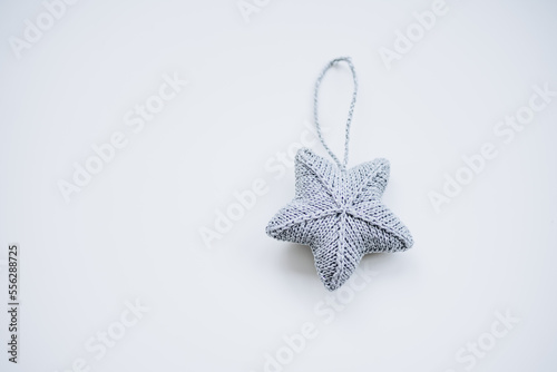 knitted decorations for the Christmas tree. handmade. do it yourself silver star on a white background. place for writing. free space. © Анна Молько