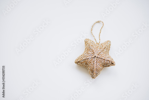 knitted decorations for the Christmas tree. handmade. do it yourself golden star on a white background. place for writing. free space.