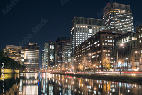 東京・丸の内のオフィスビル群と皇居のお濠 夜景 Office buildings in Marunouchi District with reflection on Imperial Palace moat at night, Tokyo, Japan