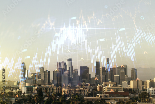 Double exposure of abstract creative financial chart hologram and world map on Los Angeles city skyscrapers background, research and strategy concept